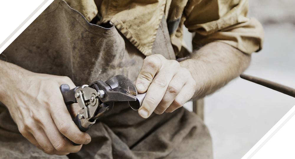 Man cutting a metal pipe